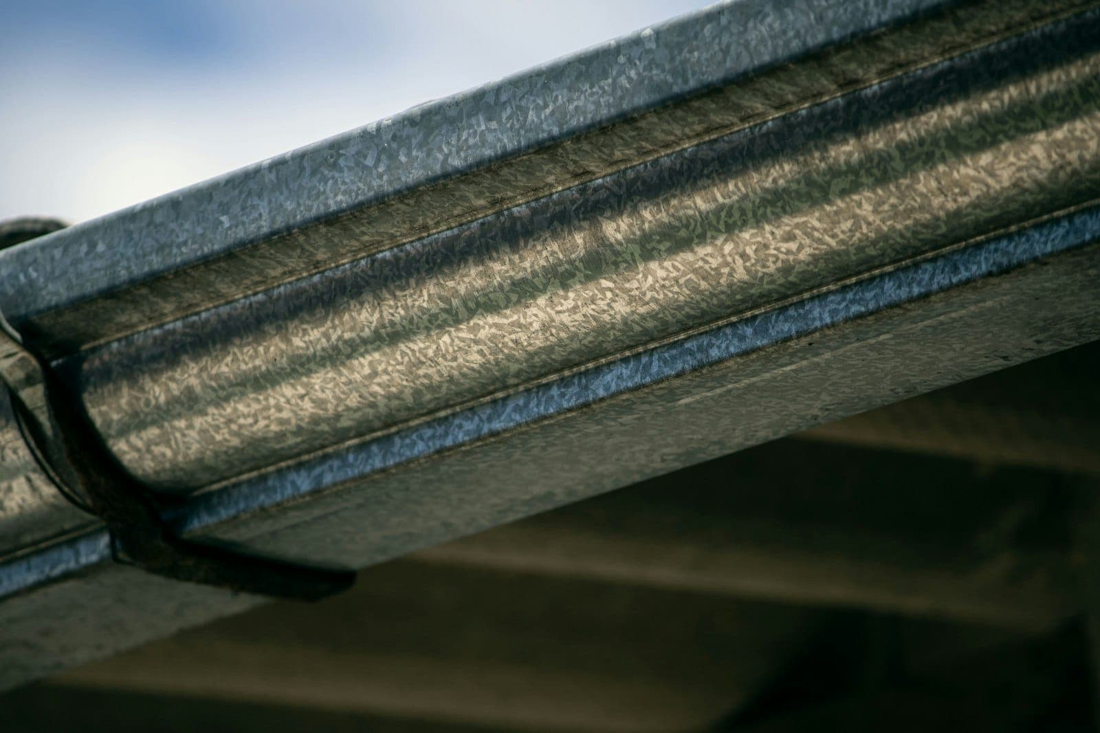 Close-up of a new metal gutter along a roof edge