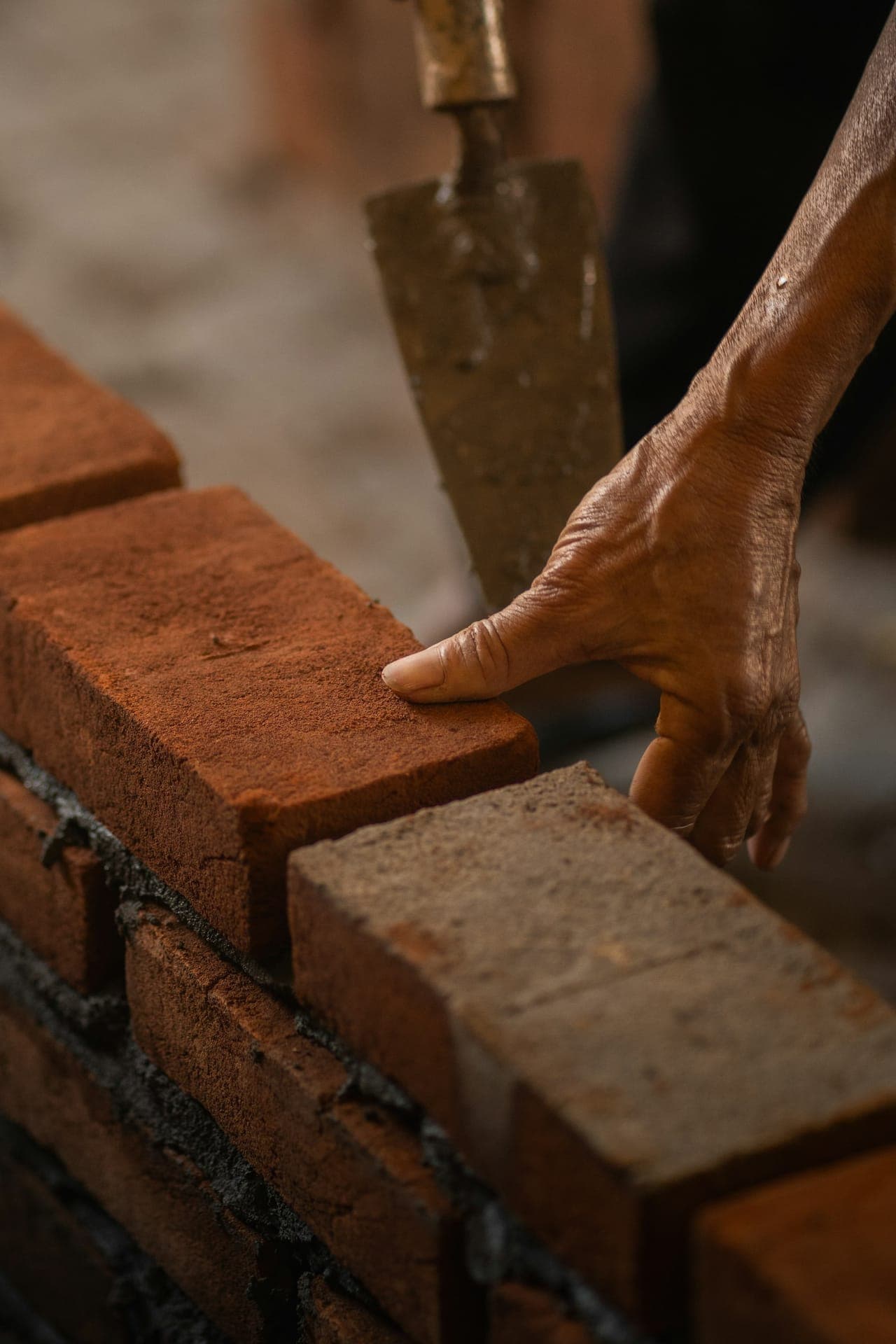 Mason setting a brick with care